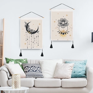 Detail of vintage moon and butterfly tapestry with wooden hanging rod and black tassels