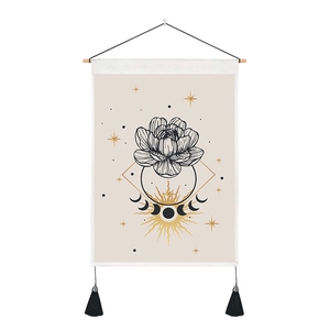 Detail of bohemian tapestry featuring lotus, moon phases, and golden sun with tassels
