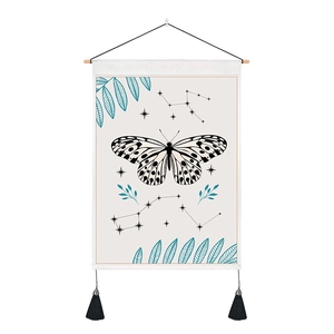 Detail of butterfly tapestry with celestial patterns, wooden rod and black tassels