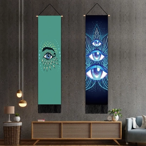 Detail of evil eye tapestries with wooden poles, fringe tassels and geometric patterns