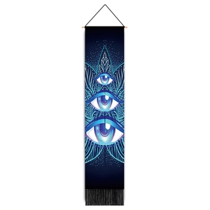 Vertical wall tapestry with mystic eyes, blue mandala patterns and black tassels detail
