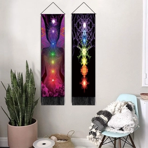Set of two chakra meditation wall tapestries with tassels in a cozy home living room