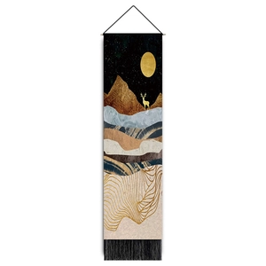 Detailed macro of vertical mountain tapestry with golden deer and black fringe trim
