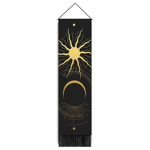 Close-up of bohemian wall tapestry with golden celestial sun, moon patterns and black tassels