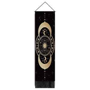 Detail of bohemian black and gold tapestry with moon phases, sun totem, and fringe tassels
