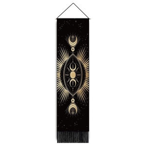 Detail of celestial sun and moon tapestry with golden prints and black fringe tassels