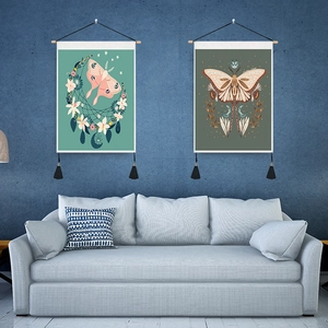 Detail of vintage butterfly and moth wall tapestries with wooden frames and tassels