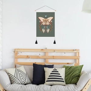 Vintage butterfly tapestry with wooden hanging rod and tassels over a grey sofa