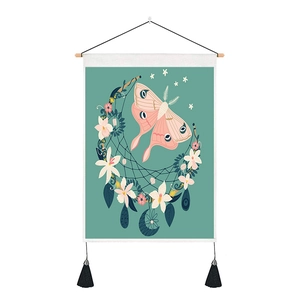 Detailed shot of vintage moth tapestry with wooden hanging rod and black tassels