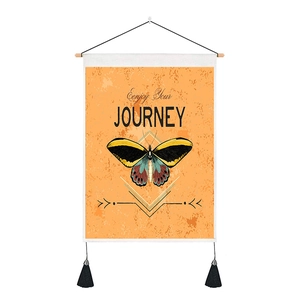 Detail of vintage butterfly tapestry with Enjoy Your Journey text and black tassels