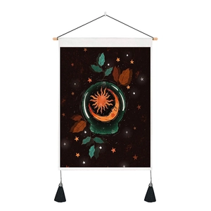 Detail of mystic sun and moon tapestry with wooden rod and black bottom tassels