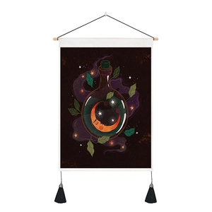 Detail of wooden hanging rod and black tassels on a celestial moon bottle tapestry