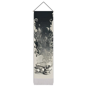 Black and white fantasy castle tapestry with moon and books hanging on a wooden rod