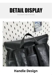 Close-up of the black PU leather backpack showing its top handle and litchi grain texture