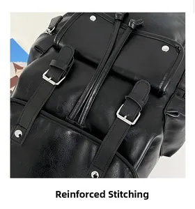 Detail showing the reinforced stitching and silver buckle on black leather backpack