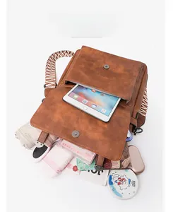 Detail view of large capacity brown bucket bag showing spacious interior for tablets