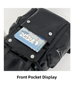 Detailed view of the black PU leather backpack front pocket with a notebook
