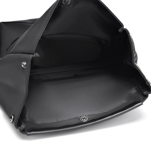 Close-up of black backpack interior showing metal snap buttons and zipper pocket detail