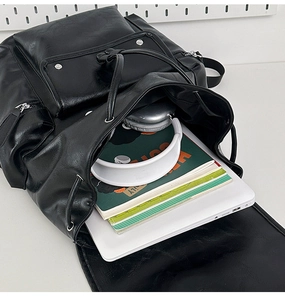 Top view of black PU leather backpack showing large interior for laptop and books