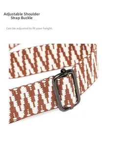 Detail of adjustable woven shoulder strap with geometric pattern and metal buckle