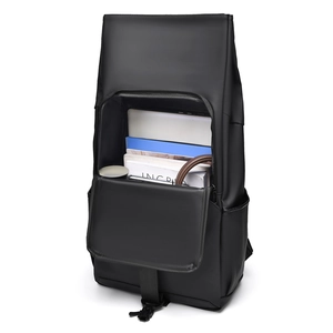 Top view of open minimalist black backpack showing spacious interior with laptop and books