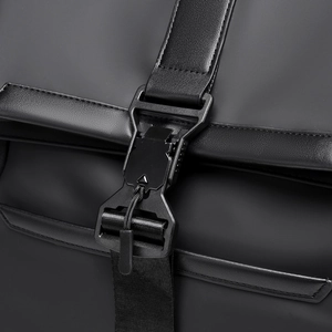 Detail of matte waterproof fabric with tactical quick-release buckle on a black backpack
