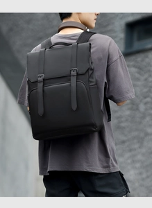 Detailed view of black waterproof business backpack with matte finish and buckle straps