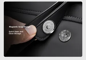 Macro detail of silver magnetic snap closure on waterproof black travel backpack