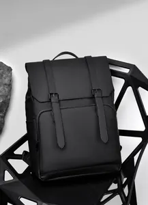 Minimalist black waterproof travel backpack with dual strap buckle and metal hardware detail