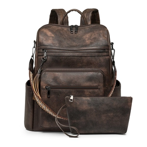 Detailed view of vintage brown leather backpack and pouch set with woven straps