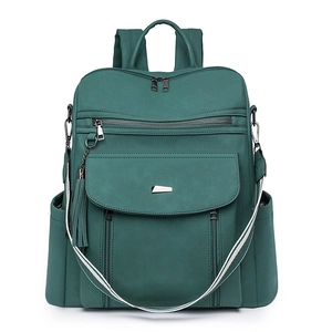 Detail of dark green PU leather backpack featuring tiered zipper pockets and striped strap