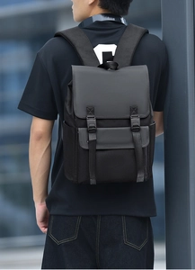 Detail view of water-resistant business backpack with dual material texture and buckle straps
