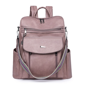 Detail of dusty rose PU leather backpack with colorful woven strap and multiple zippers