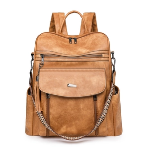 Detailed front view of vintage brown PU leather backpack with tassel and woven strap