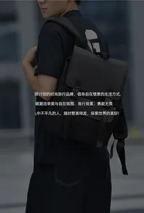 Close-up of black waterproof business backpack with double buckle flap and side pockets