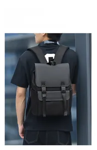 Rear view of model wearing a waterproof black and grey minimalist commuter laptop backpack