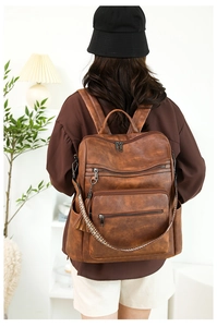 Detail of vintage leopard print backpack with bohemian strap and soft leather texture