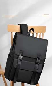 Close-up of black water-resistant backpack with flap top and buckle on a wooden chair