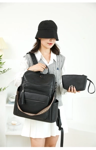 Detail of black leather backpack with ethnic geometric strap and matching small pouch