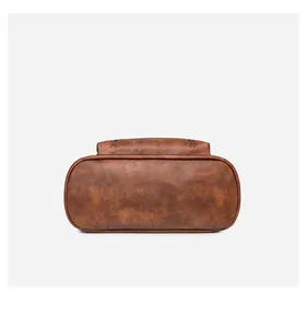 Detailed bottom view of large capacity brown PU leather backpack with durable stitching