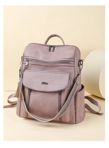 Detail of grey-purple PU leather backpack with colorful woven strap and tassel
