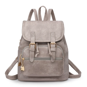 Close-up of grey litchi texture PU backpack with golden buckles and drawstring closure