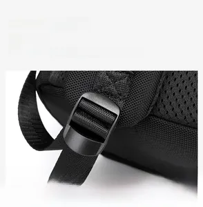 Detail view of the black business backpack showing an adjustable strap with a durable buckle