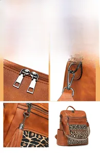 Detail of thickened gold-tone hardware and leopard print pocket on brown leather backpack