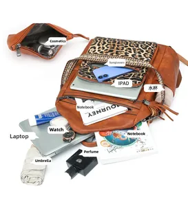 Spacious leopard print backpack interior showing storage for laptop and accessories