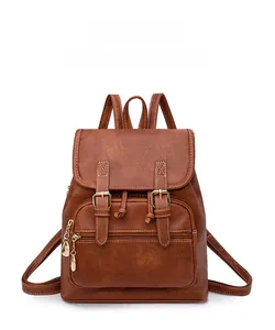 Detailed view of brown vintage PU leather backpack with buckle and metallic pendant