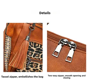 Detail of leopard print stitching, litchi grain leather, and dual tassel metal zippers