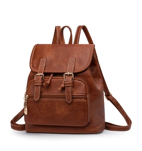 Detailed close-up of brown vintage PU leather texture and gold leaf zipper on the backpack