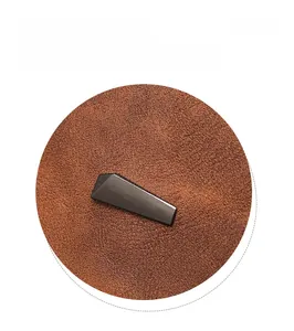Detailed close-up of dark brown PU leather texture and sleek black metal decorative bar