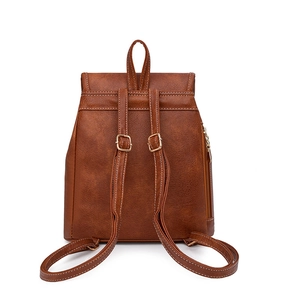 Detailed back view of brown lychee grain PU backpack showing adjustable straps and gold zippers